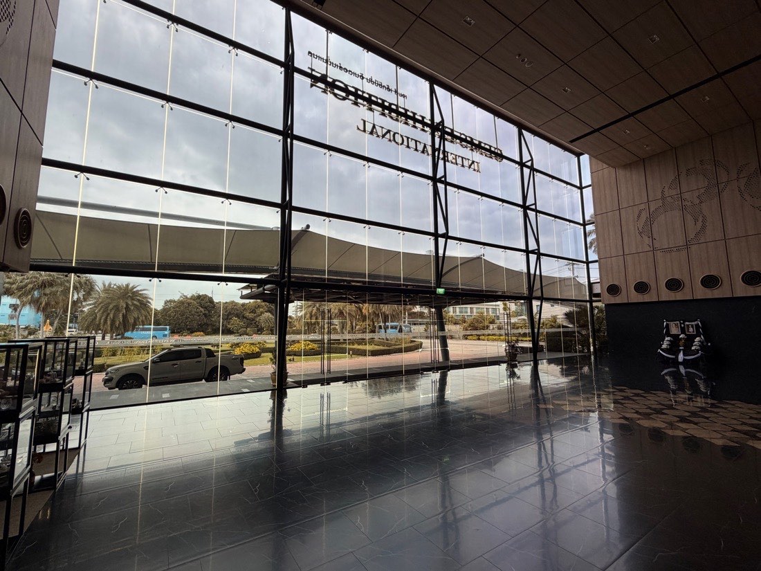 The glazed entrance hall looking out to the covered drop-off