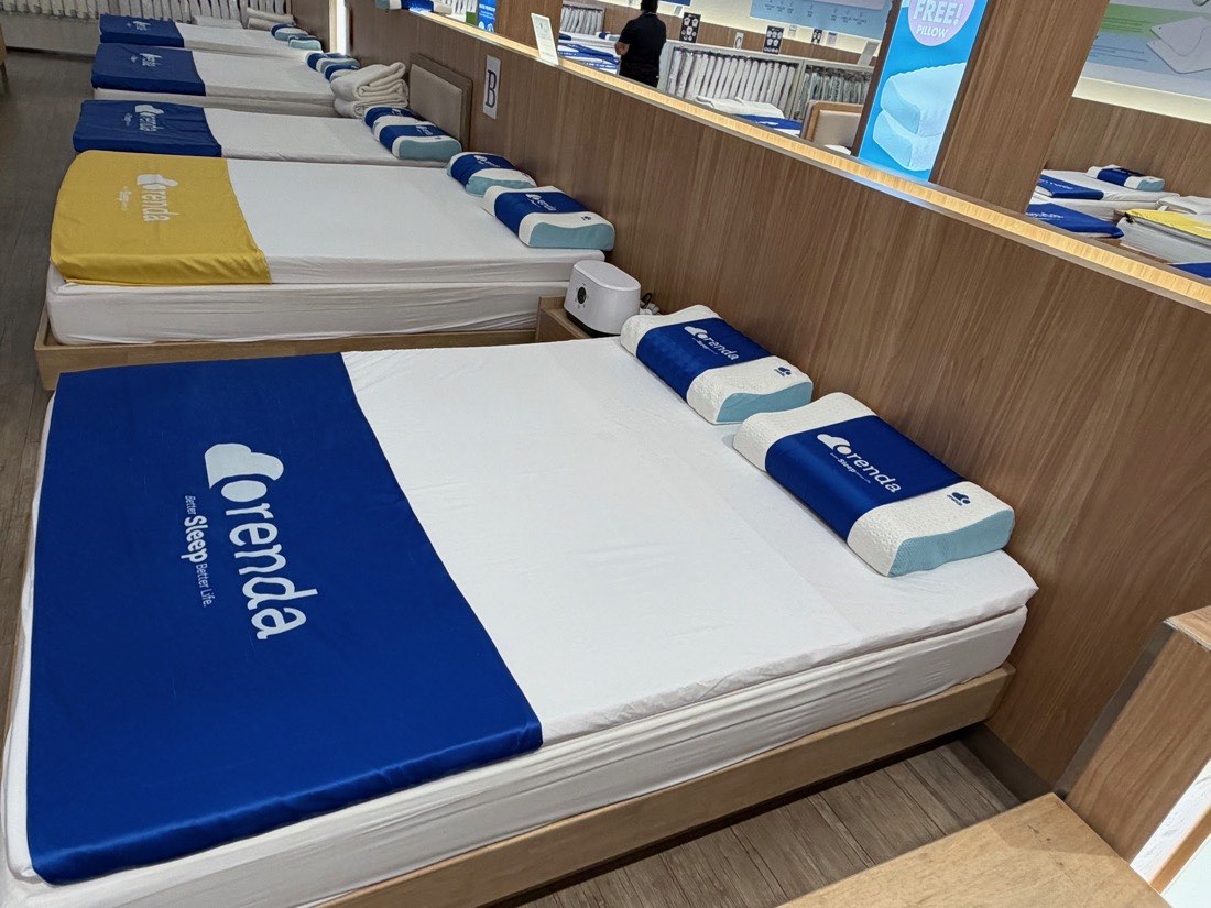 Rows of latex mattresses and pillows in the sleep department